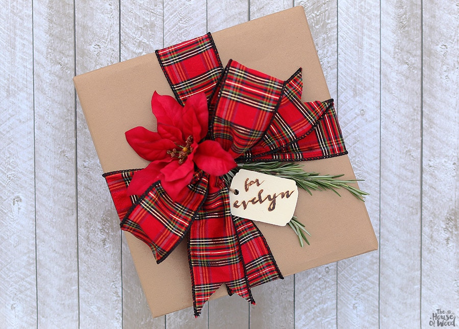 Dressing up kraft paper is easy with some pretty ribbon, sprigs of rosemary, and a wood-burned gift tag