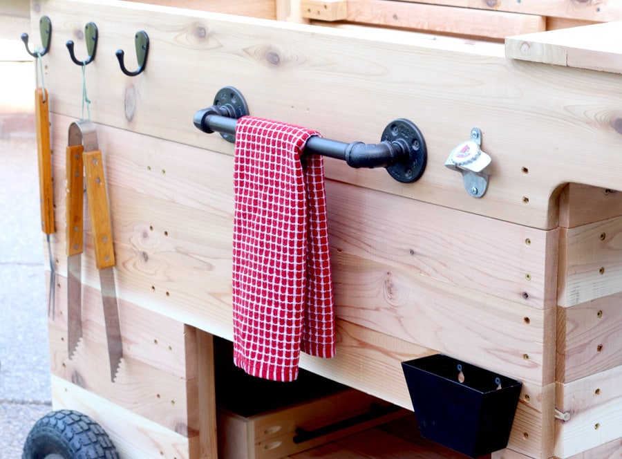 Outdoor party station mobile cart featuring storage for a large cooler, drawer that pulls out and doubles as a serving tray, pipe towel bar, and kiddie table! So COOL!