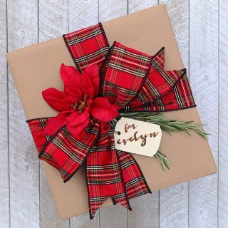 Dressing up kraft paper is easy with some pretty ribbon, sprigs of rosemary, and a wood-burned gift tag! Via Jen Woodhouse