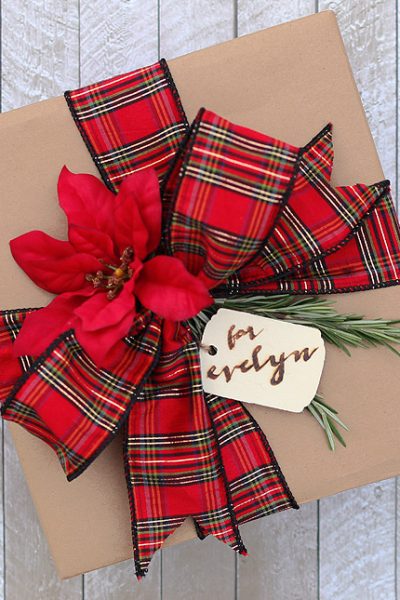 Dressing up kraft paper is easy with some pretty ribbon, sprigs of rosemary, and a wood-burned gift tag! Via Jen Woodhouse