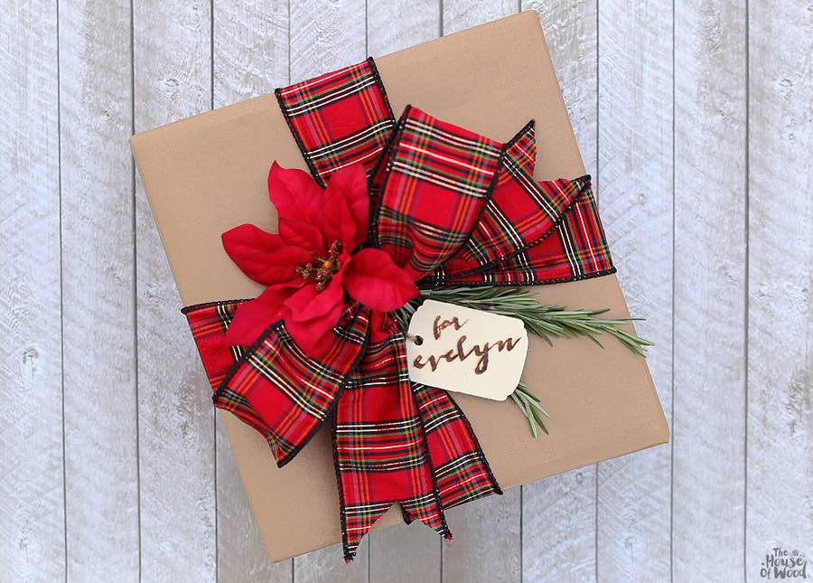 Dressing up kraft paper is easy with some pretty ribbon, sprigs of rosemary, and a wood-burned gift tag! Via Jen Woodhouse