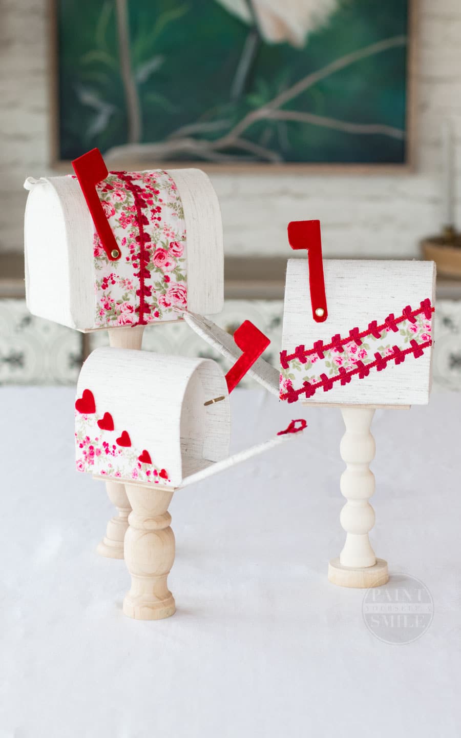Easy DIY Valentine's Mailboxes made from fabric, cardboard, and wooden candle sticks. 