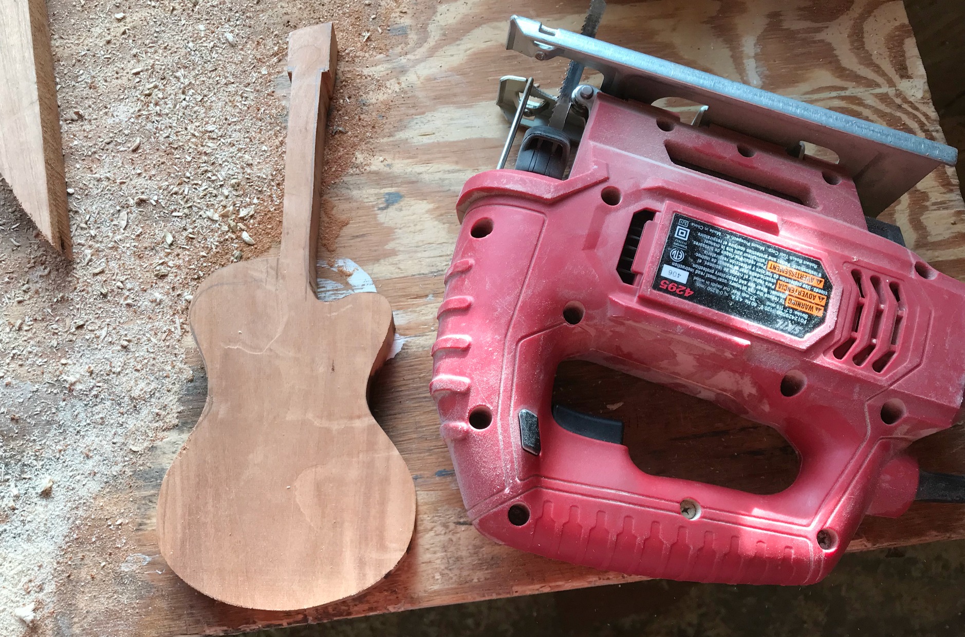 Use jig saw to cut scrap wood into Guitar shape