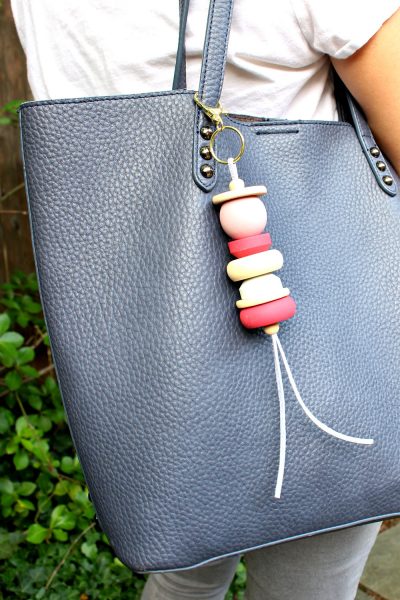 painted wood and leather purse bag tassel