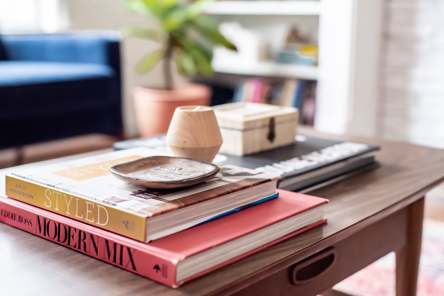 stacked books on mid century coffee table