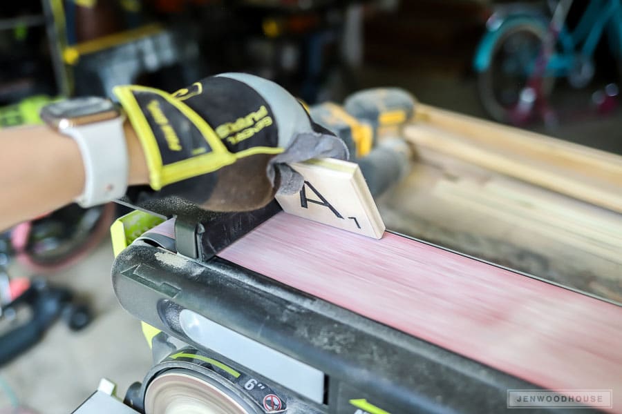 Sanding giant wooden Scrabble letters