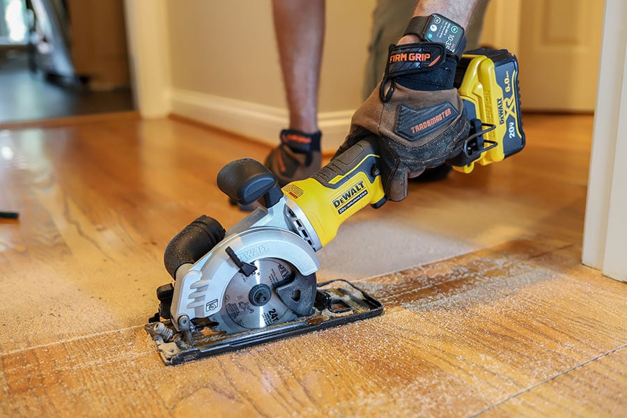 Dewalt mini circular saw cutting hardwood flooring