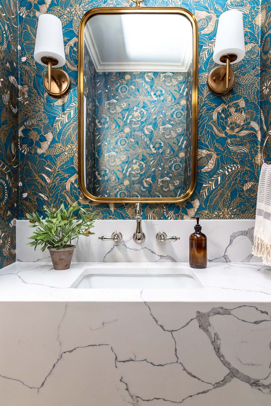 powder room with statement wallpaper and floating marble vanity
