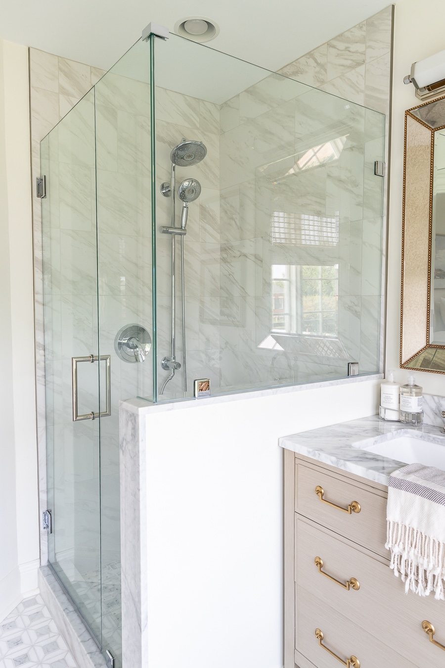 Gorgeous bathroom renovation with marble tile and glass shower