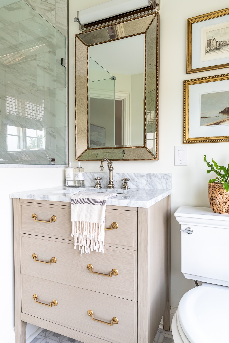 Beautiful warm wood vanity with marble top and storage drawers