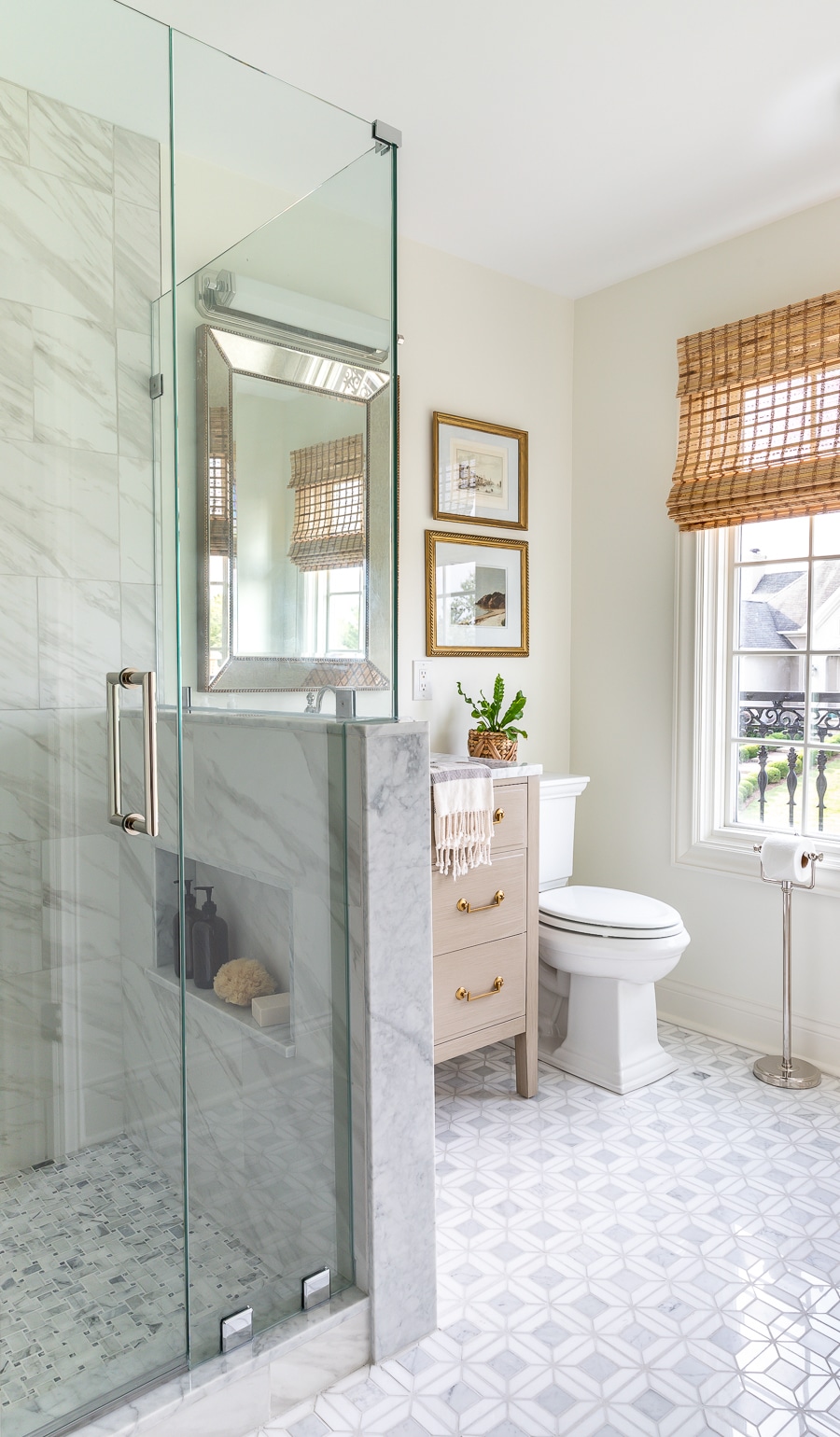 Stunning guest bathroom renovation featuring marble mosaic tile and vintage accents