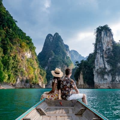 couple on longtail boat visiting Khao Sok national park in Phangnga Thailand, Khao Sok National Park with longtail boat for travelers, Cheow Lan lake, Ratchaphapha dam