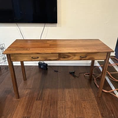 Mahogany desk with black walnut border, legs, and face plate